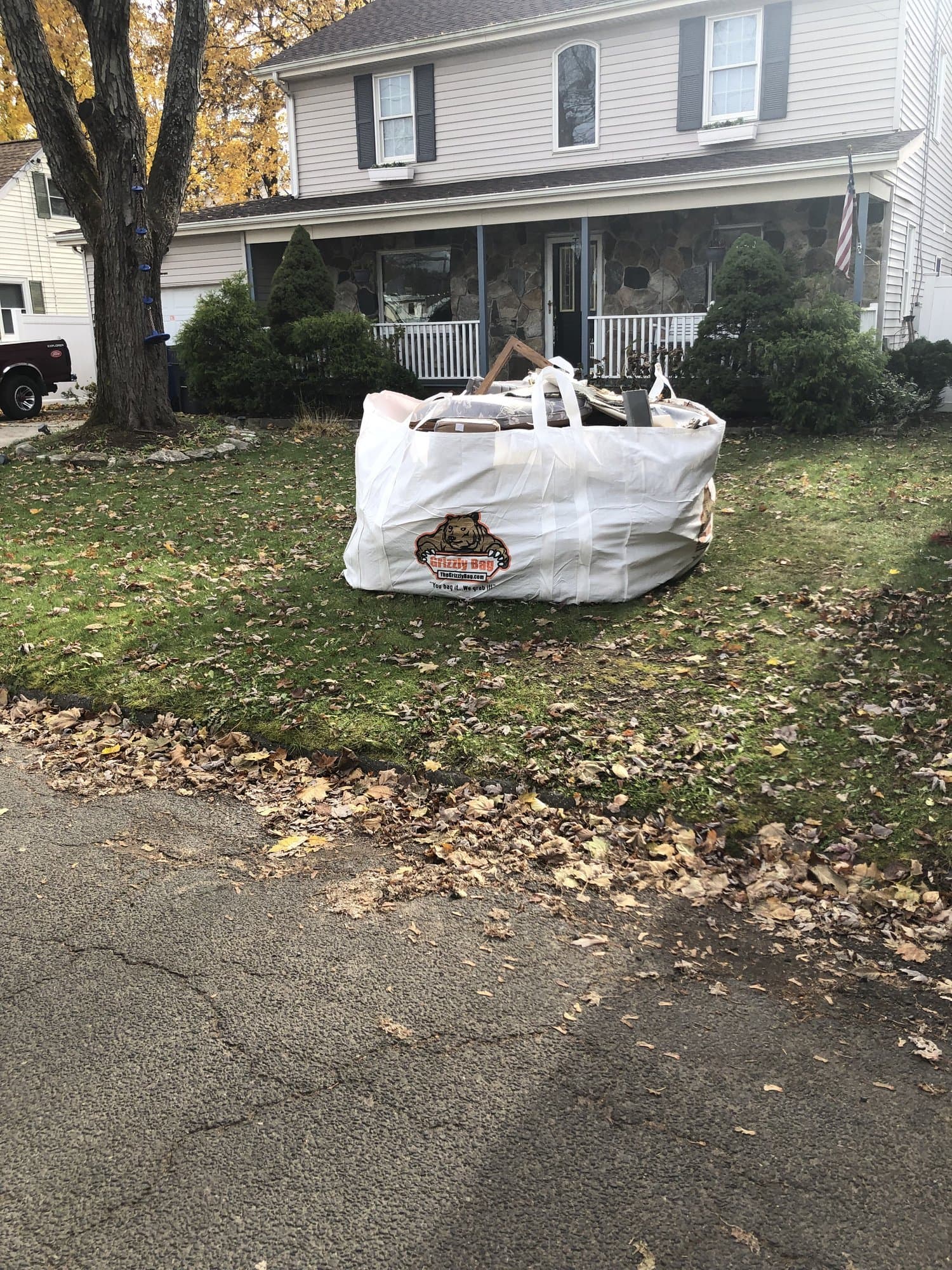 A dumpster bag part-way through a yard cleanout, loaded with debris and ready for collection in Hampton Roads, VA