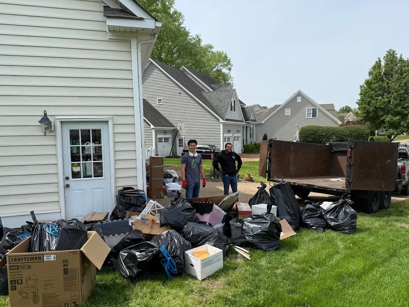Garage cleanout in Norfolk, VA — Noah and Harry hauling boxes for a local family