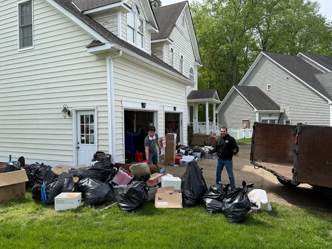 Yard debris removal in Hampton Roads — ProGrade Cleanups clearing brush for a homeowner